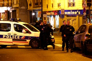 epa05023768 Police officers arrive at the scene of a shooting in Paris, France, 13 November 2015. A shooting occurred in a restaurant late 13 November in Paris, with newspaper Liberation reporting several dead. Explosions have also been reported near the Stade de France. (YOAN VALAT/EPA/CP)
